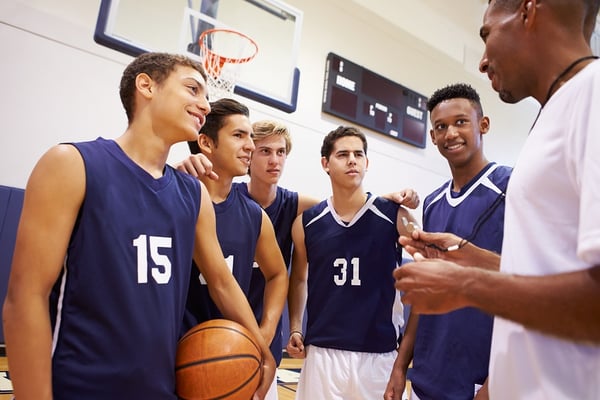 Coach with boys high school Basketball team