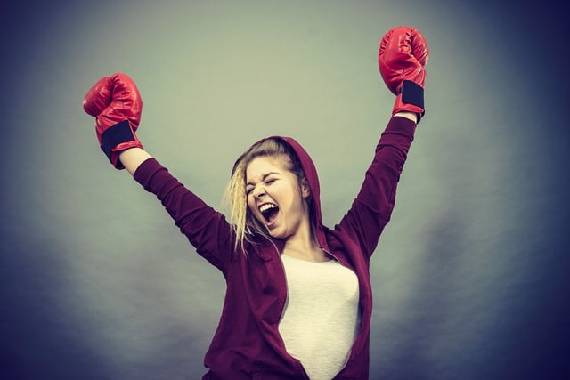 BS D Female in red celebrating success with boxing gloves.jpg