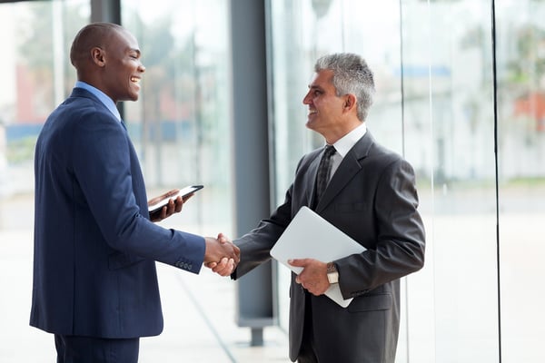 2 men happily shaking hands