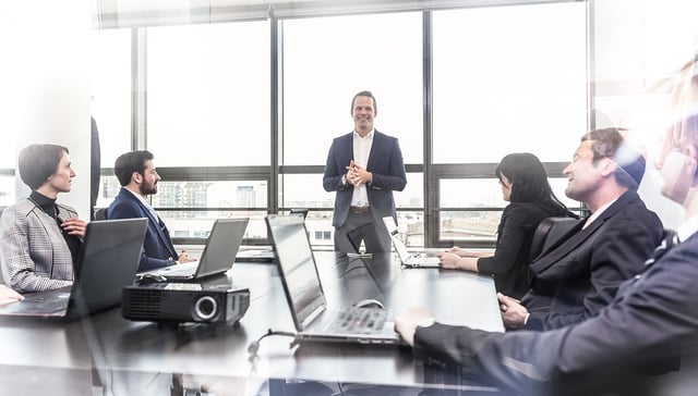 Male Leader Boosting Team Morale in Meeting