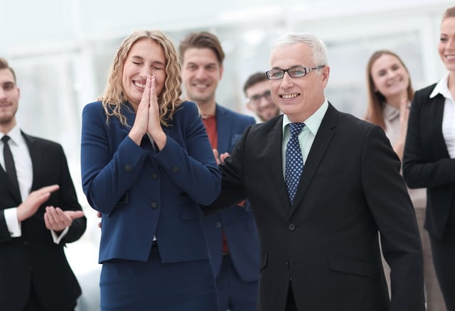 BS Older Hispanic Leader congratulated by team.jpg