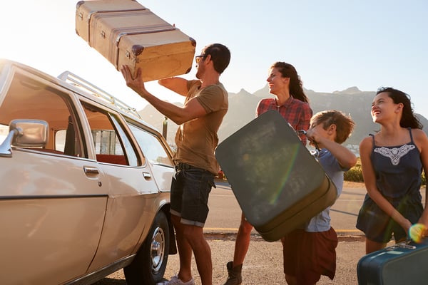 Family loading car for road trip vacation