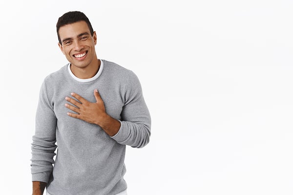 Happy-And-grateful hispanic man with hand on chest 