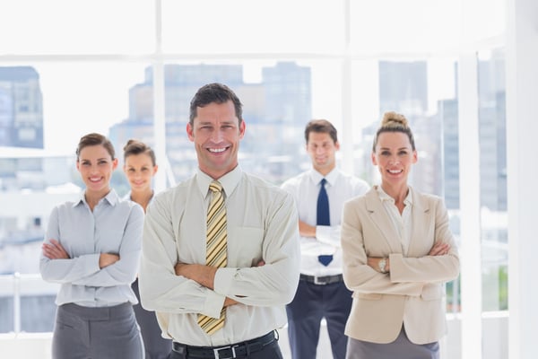 Smiling manager with his team in a modern office