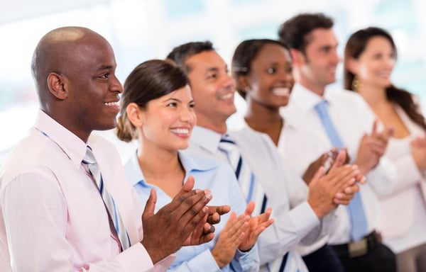 Successful business presentation and a group of people applauding