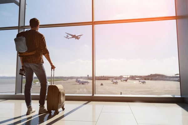 bigstock-man watching airplane with suitcase traveler